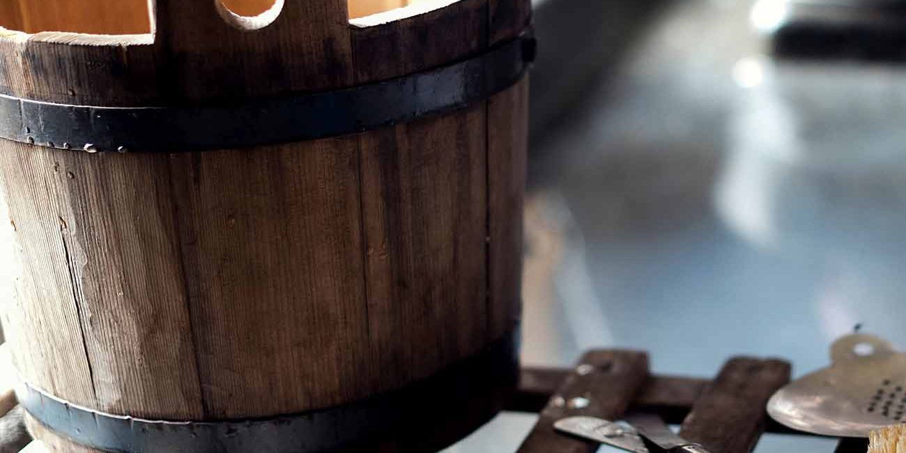 A wooden bucket sitting on top of a table.