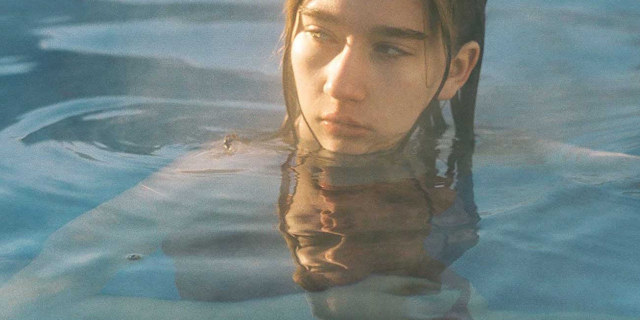 A woman in the water with her head above the surface.