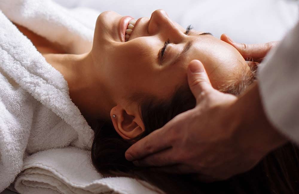 A person getting their head washed by a masseur.