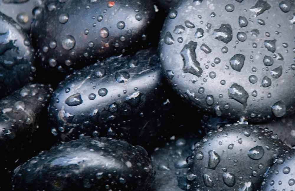 A close up of water drops on some rocks