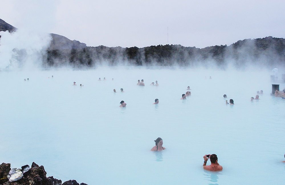 A group of people swimming in the blue water.