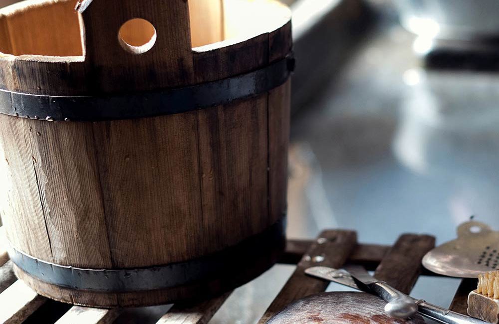 A wooden bucket sitting on top of a table.