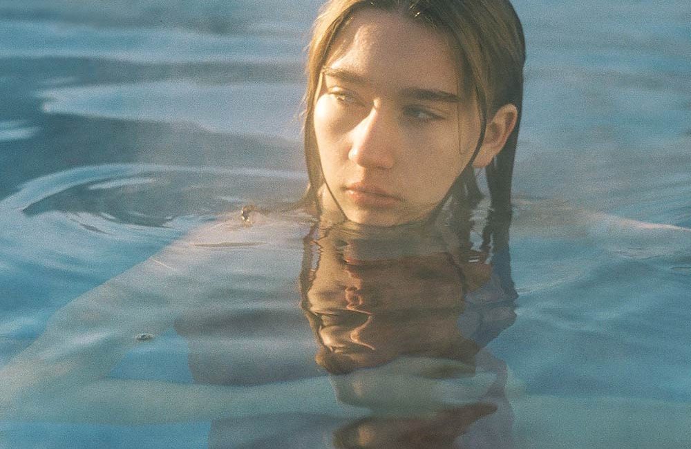 A woman in the water with her head above the surface.