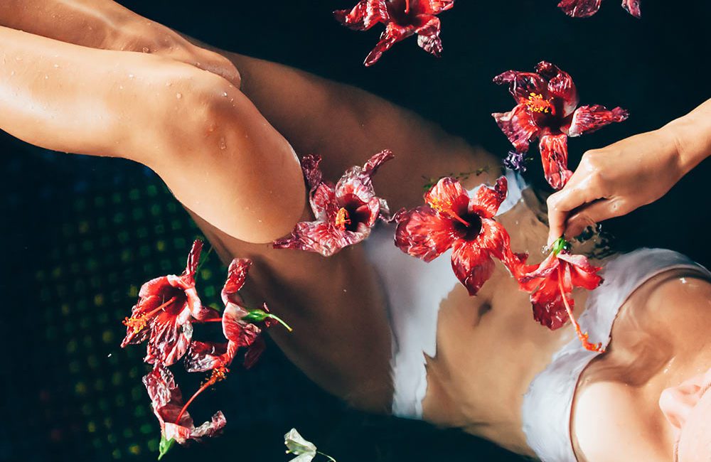 A woman in white shirt and red flowers