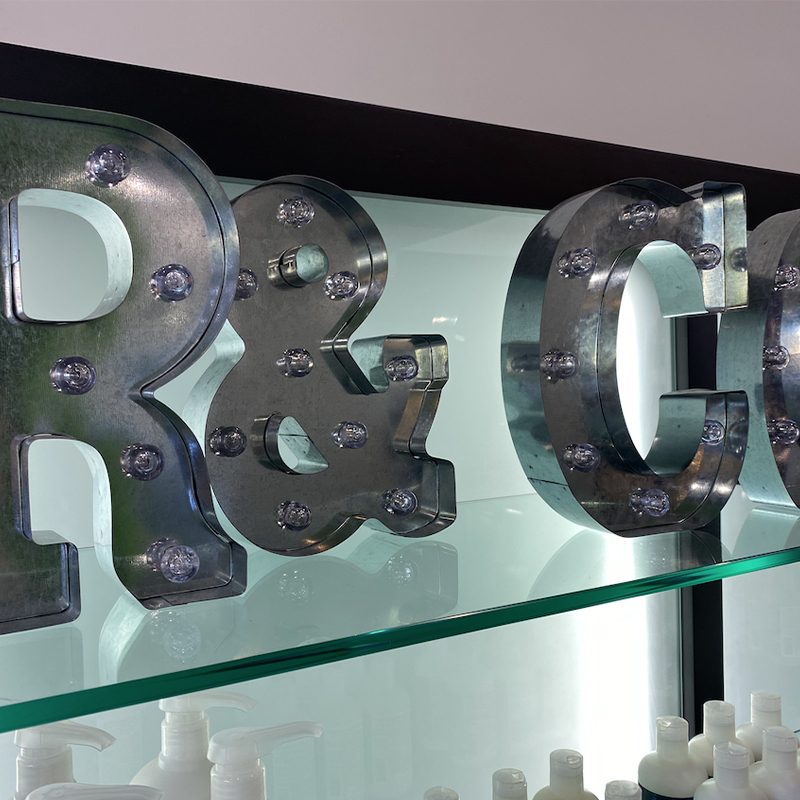 A glass display case with metal letters and numbers.
