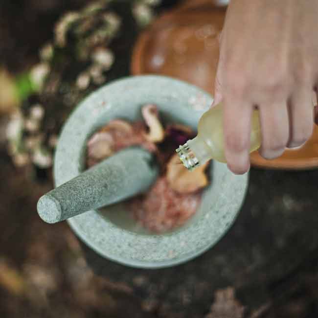 A person is using a mortar and pestle.