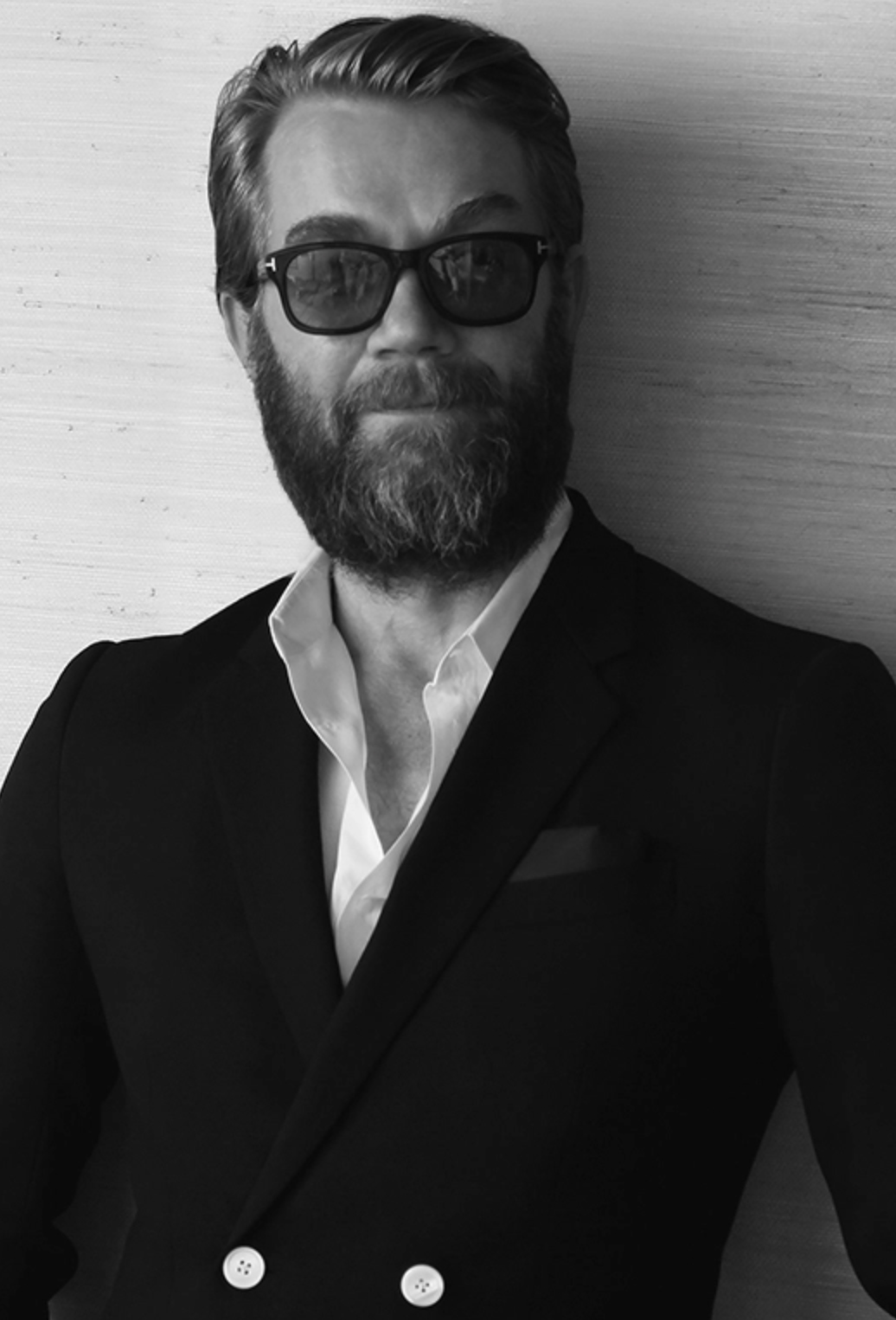 A man with beard and glasses in suit